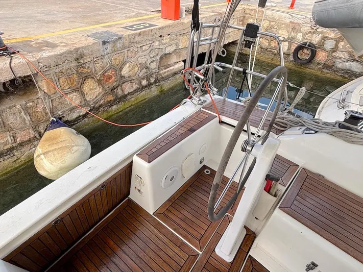 Sunshine Yacht Photos Pics Cockpit of 2014 Hanse 345 sailboat with wooden deck and steering wheel at dock.