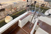 Cockpit of 2014 Hanse 345 sailboat with wooden deck and steering wheel at dock.