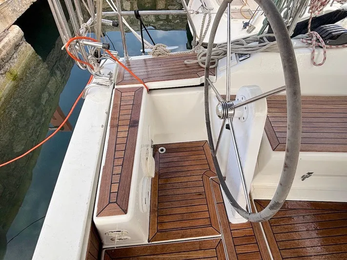 Sunshine Yacht Photos Pics Steering wheel and deck of 2014 Hanse 345 sailboat with wooden finish.