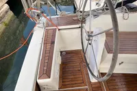 Steering wheel and deck of 2014 Hanse 345 sailboat with wooden finish.
