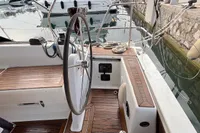 Cockpit of 2014 Hanse 345 sailboat with wooden deck and steering wheel.
