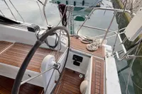 2014 Hanse 345 sailboat cockpit with wooden deck and steering wheel.