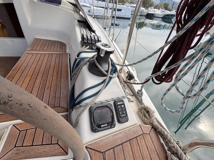 Sunshine Yacht Photos Pics 2014 Hanse 345 sailboat deck with winch, ropes, and wooden flooring in marina.