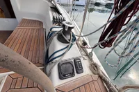 2014 Hanse 345 sailboat deck with winch, ropes, and wooden flooring in marina.