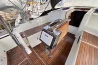 2014 Hanse 345 yacht cockpit with wooden flooring and steering wheel.