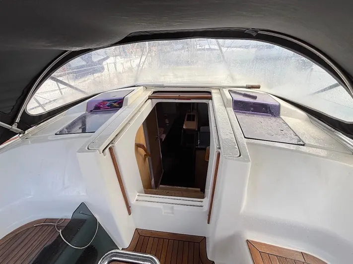 Sunshine Yacht Photos Pics Cockpit view of 2014 Hanse 345 sailboat, featuring wooden flooring and cabin entrance.