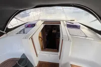 Cockpit view of 2014 Hanse 345 sailboat, featuring wooden flooring and cabin entrance.