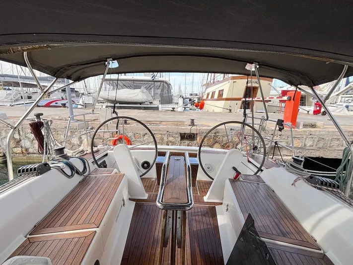 Sunshine Yacht Photos Pics 2014 Hanse 345 sailboat cockpit with dual steering wheels and wooden seating.