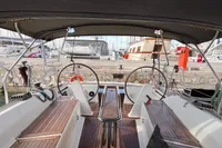 2014 Hanse 345 sailboat cockpit with dual steering wheels and wooden seating.