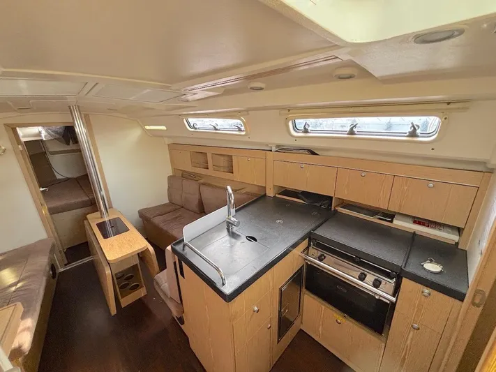 Sunshine Yacht Photos Pics Interior of a 2014 Hanse 345 yacht featuring a modern kitchen and cozy seating area.