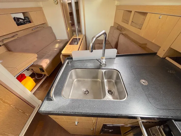 Sunshine Yacht Photos Pics Interior of 2014 Hanse 345 yacht featuring a modern kitchen and cozy seating area.