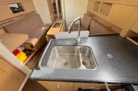 Interior of 2014 Hanse 345 yacht featuring a modern kitchen and cozy seating area.