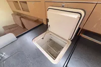 Built-in cooler in 2014 Hanse 345 yacht interior, featuring wooden cabinetry and seating.