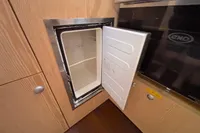 Open mini fridge in 2014 Hanse 345 yacht kitchen interior.
