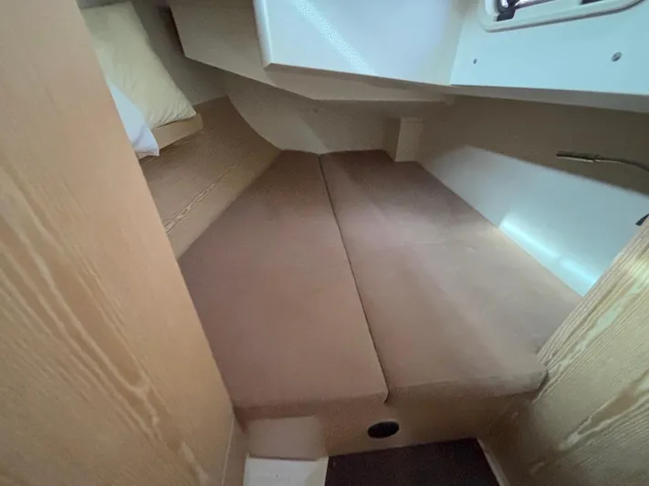 Sunshine Yacht Photos Pics 2014 Hanse 345 interior cabin with beige cushions and wooden accents.