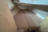 2014 Hanse 345 interior cabin with beige cushions and wooden accents.