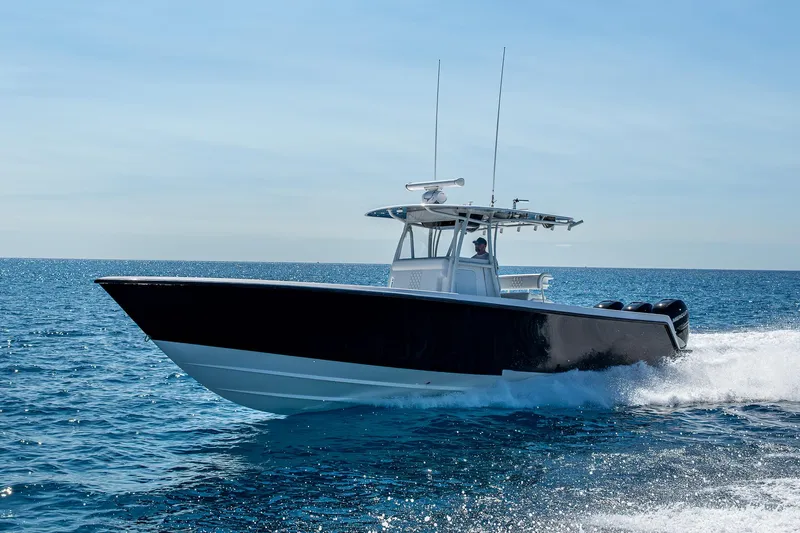  Yacht Photos Pics 2017 Contender 39 ST boat cruising on open water under clear skies.