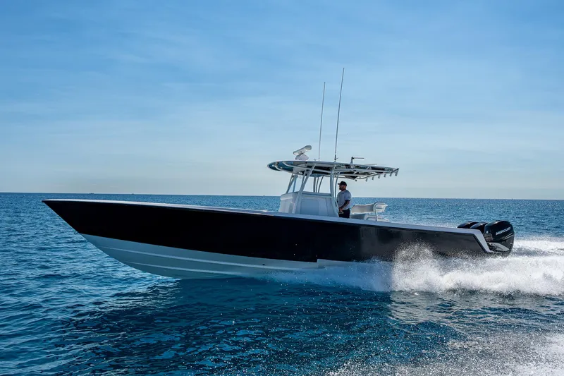  Yacht Photos Pics 2017 Contender 39 ST boat cruising on open water under clear blue sky.