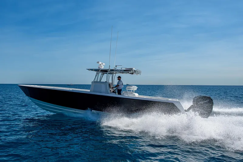  Yacht Photos Pics 2017 Contender 39 ST boat cruising on open ocean under clear blue sky.