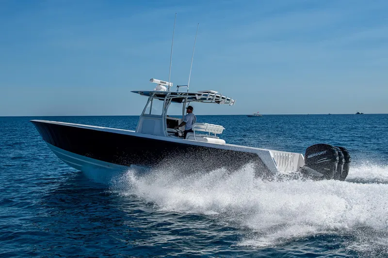  Yacht Photos Pics 2017 Contender 39 ST boat cruising on open water, creating a wake.