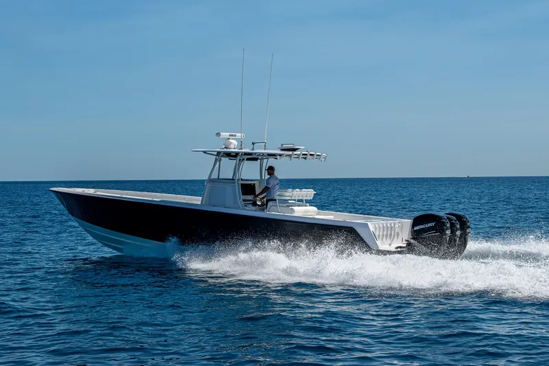  Yacht Photos Pics 2017 Contender 39 ST boat cruising on open water, side view.