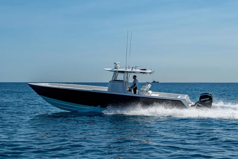  Yacht Photos Pics 2017 Contender 39 ST boat cruising on open water under clear blue sky.