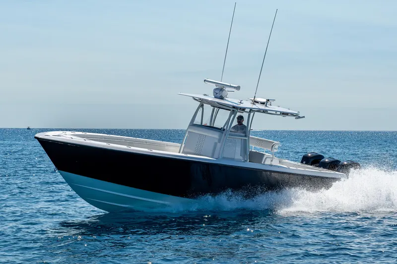  Yacht Photos Pics 2017 Contender 39 ST boat cruising on open water, side view.