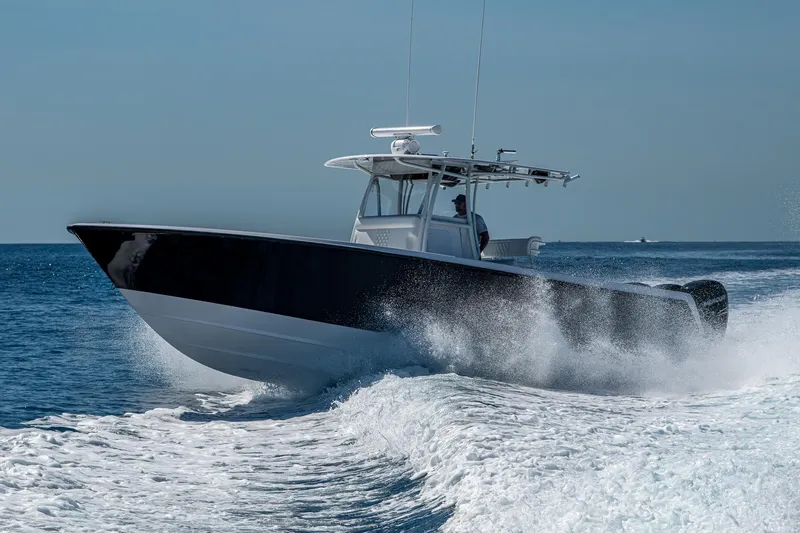  Yacht Photos Pics 2017 Contender 39 ST boat cruising on open water, creating a dynamic wake.