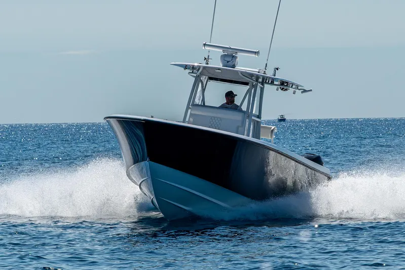  Yacht Photos Pics 2017 Contender 39 ST boat cruising on open water, creating a dynamic splash.