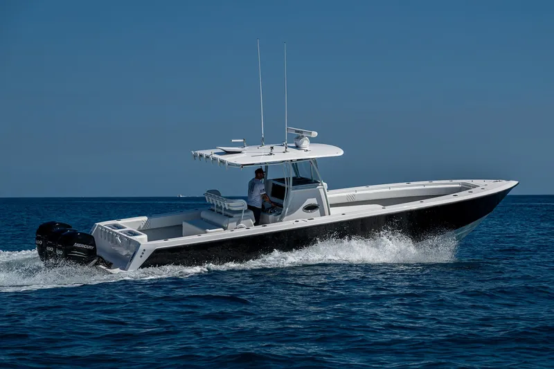  Yacht Photos Pics 2017 Contender 39 ST boat cruising on open water under clear blue sky.