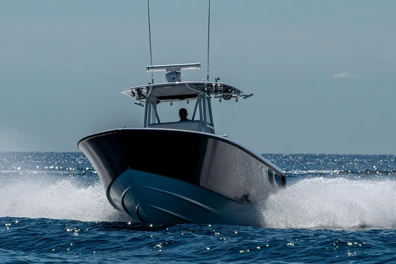  Yacht Photos Pics 2017 Contender 39 ST boat cruising swiftly on open water.