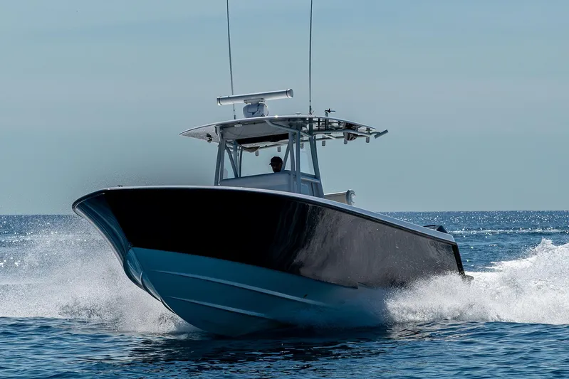  Yacht Photos Pics 2017 Contender 39 ST boat cruising on open water, creating a splash.