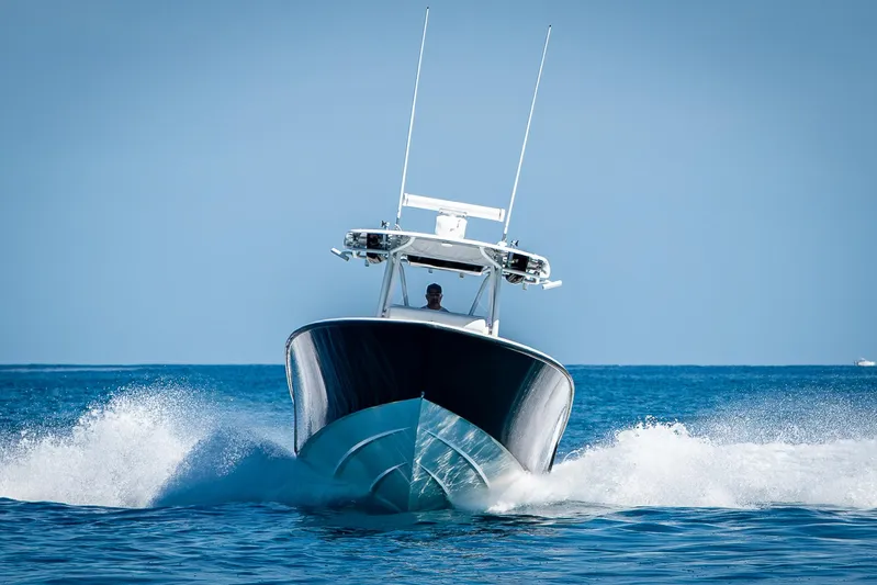  Yacht Photos Pics 2017 Contender 39 ST boat cruising on open water, creating a splash.