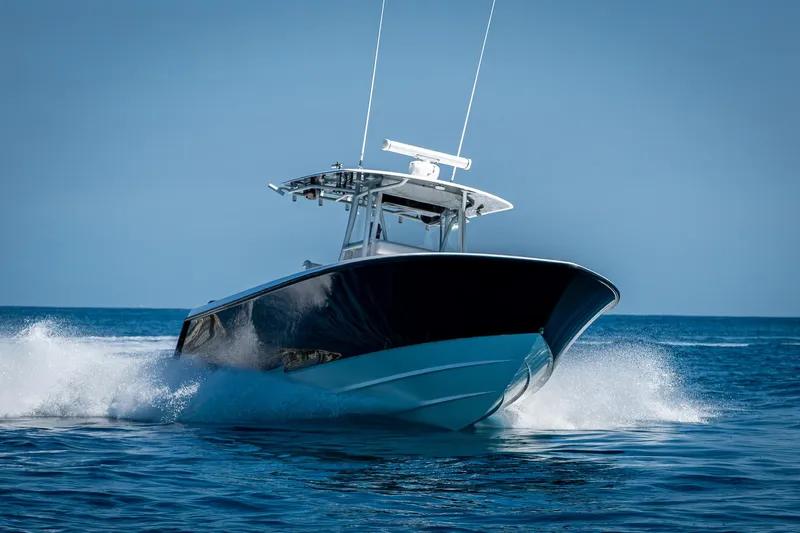  Yacht Photos Pics 2017 Contender 39 ST boat cruising on open water, creating a splash.