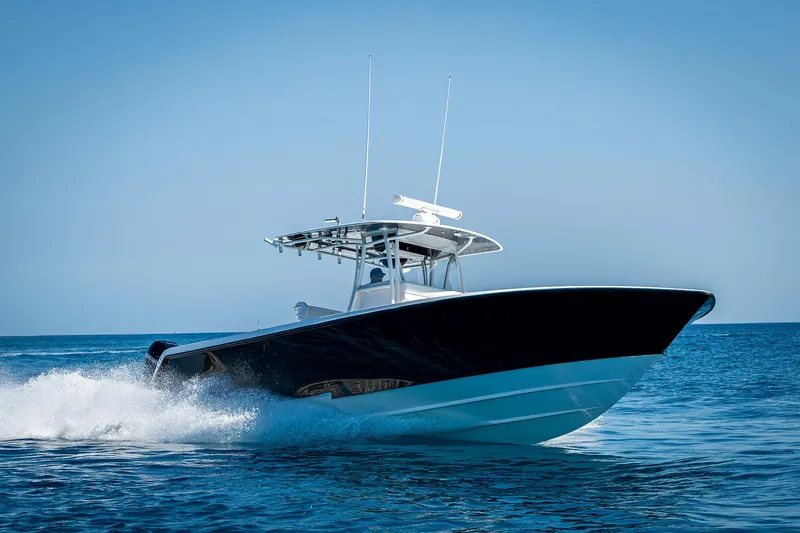  Yacht Photos Pics 2017 Contender 39 ST boat cruising on open water under clear blue sky.