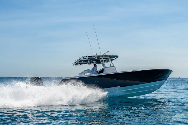  Yacht Photos Pics 2017 Contender 39 ST boat cruising on open water, creating a splash.