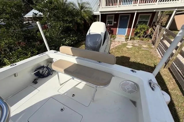  Yacht Photos Pics 2017 Stuart 27 boat with seating, outboard motor, and residential background.