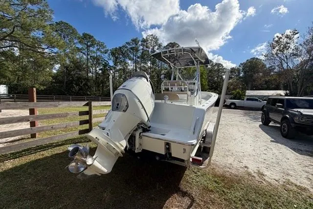  Yacht Photos Pics 2017 Stuart 27 boat with outboard motor in a sunny outdoor setting.