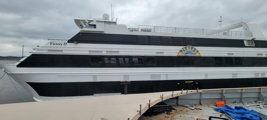 Custom Victory 11 yacht, 1981 model, docked under cloudy skies.
