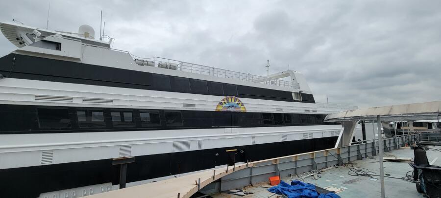 Custom Victory 11 ship docked, 1981 model, overcast sky.