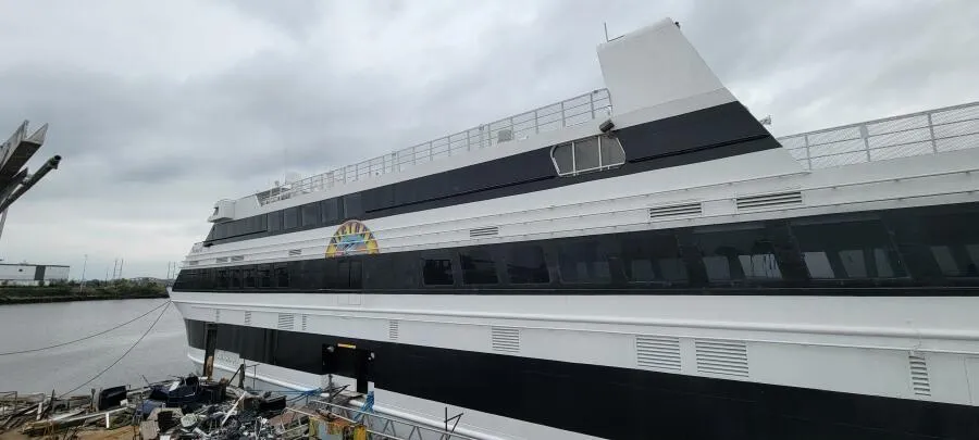 Custom Victory 11 ship, 1981 model, docked by the river under cloudy skies.