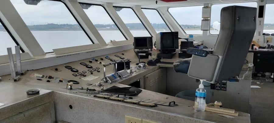 Control room of 1981 Custom Victory 11 ship with navigation equipment and panoramic windows.