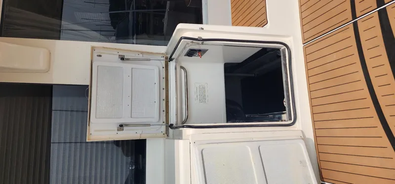  Yacht Photos Pics 2004 Silverton 48 Convertible yacht hatch with open door, showcasing interior access.