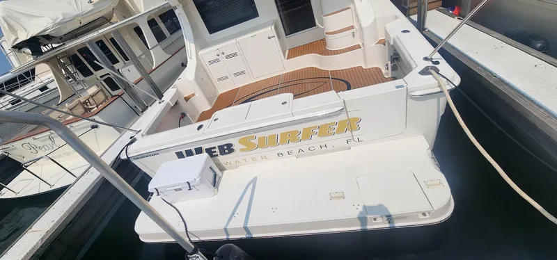  Yacht Photos Pics 2004 Silverton 48 Convertible yacht docked, featuring spacious deck and elegant design.