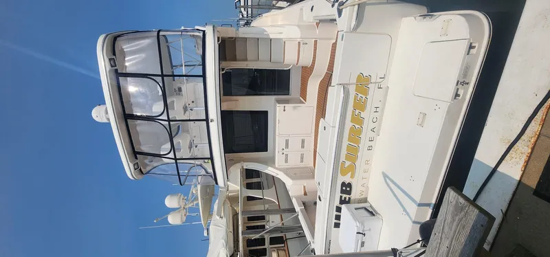  Yacht Photos Pics 2004 Silverton 48 Convertible yacht docked under clear blue sky.