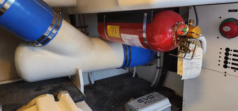  Yacht Photos Pics Engine room of 2004 Silverton 48 Convertible with fire extinguisher and piping system.