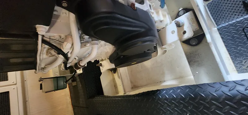  Yacht Photos Pics Engine room of a 2004 Silverton 48 Convertible yacht, featuring mechanical components and diamond plate flooring.