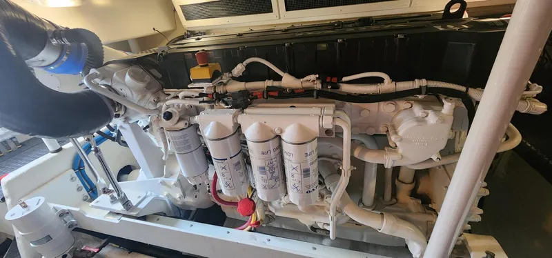  Yacht Photos Pics Engine room of a 2004 Silverton 48 Convertible yacht, showcasing detailed machinery.