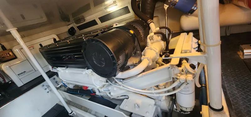  Yacht Photos Pics Engine room of a 2004 Silverton 48 Convertible yacht, showcasing detailed machinery.