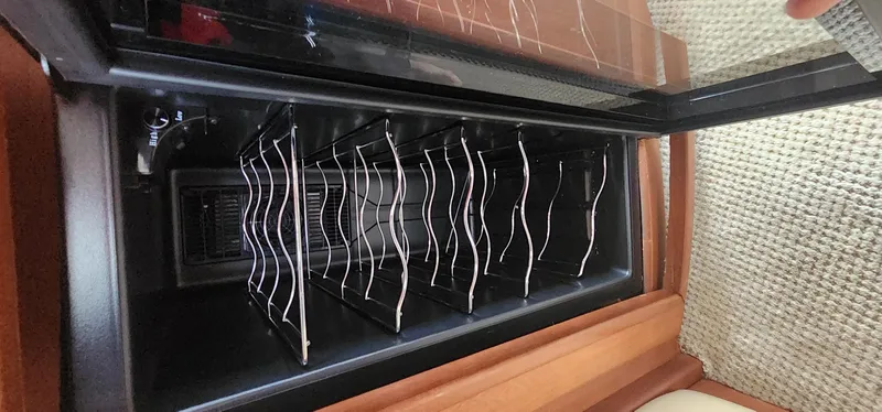  Yacht Photos Pics Wine rack inside a 2004 Silverton 48 Convertible yacht, featuring sleek metal holders.